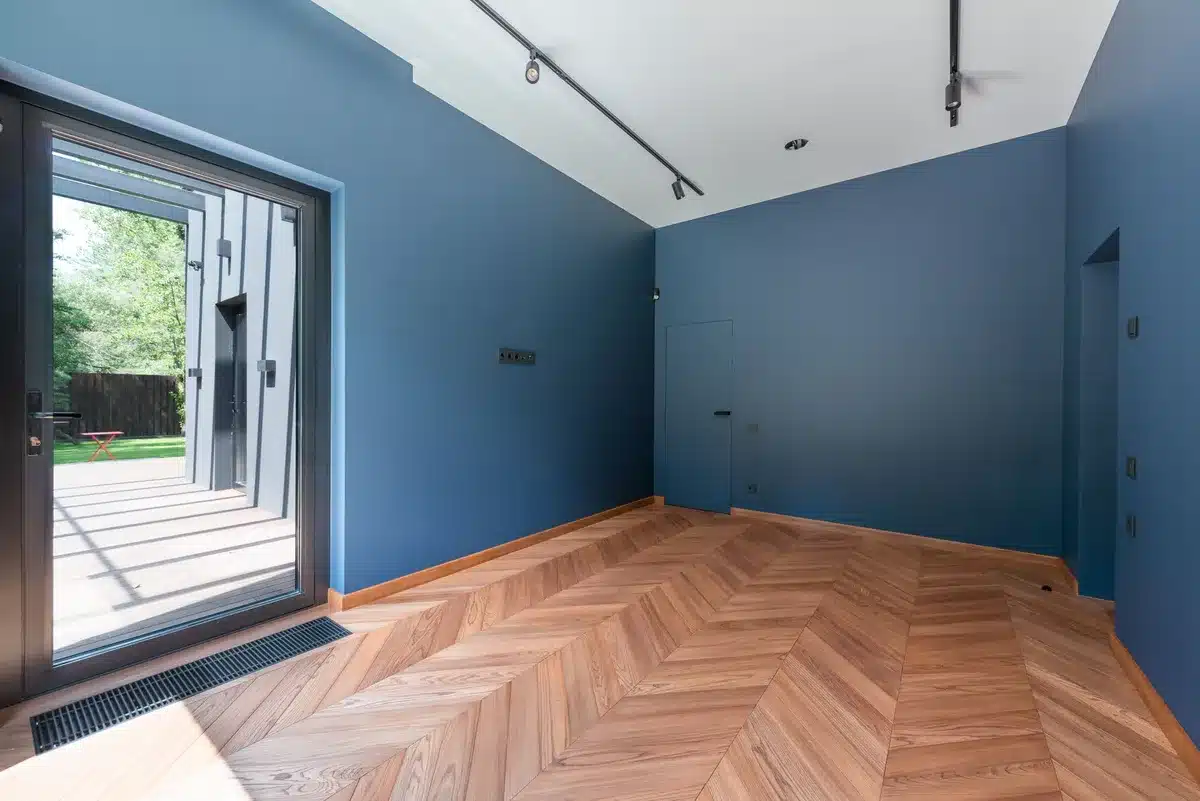Installation d'une baie vitrée accordéon dans un salon avec espace de dégagement visible