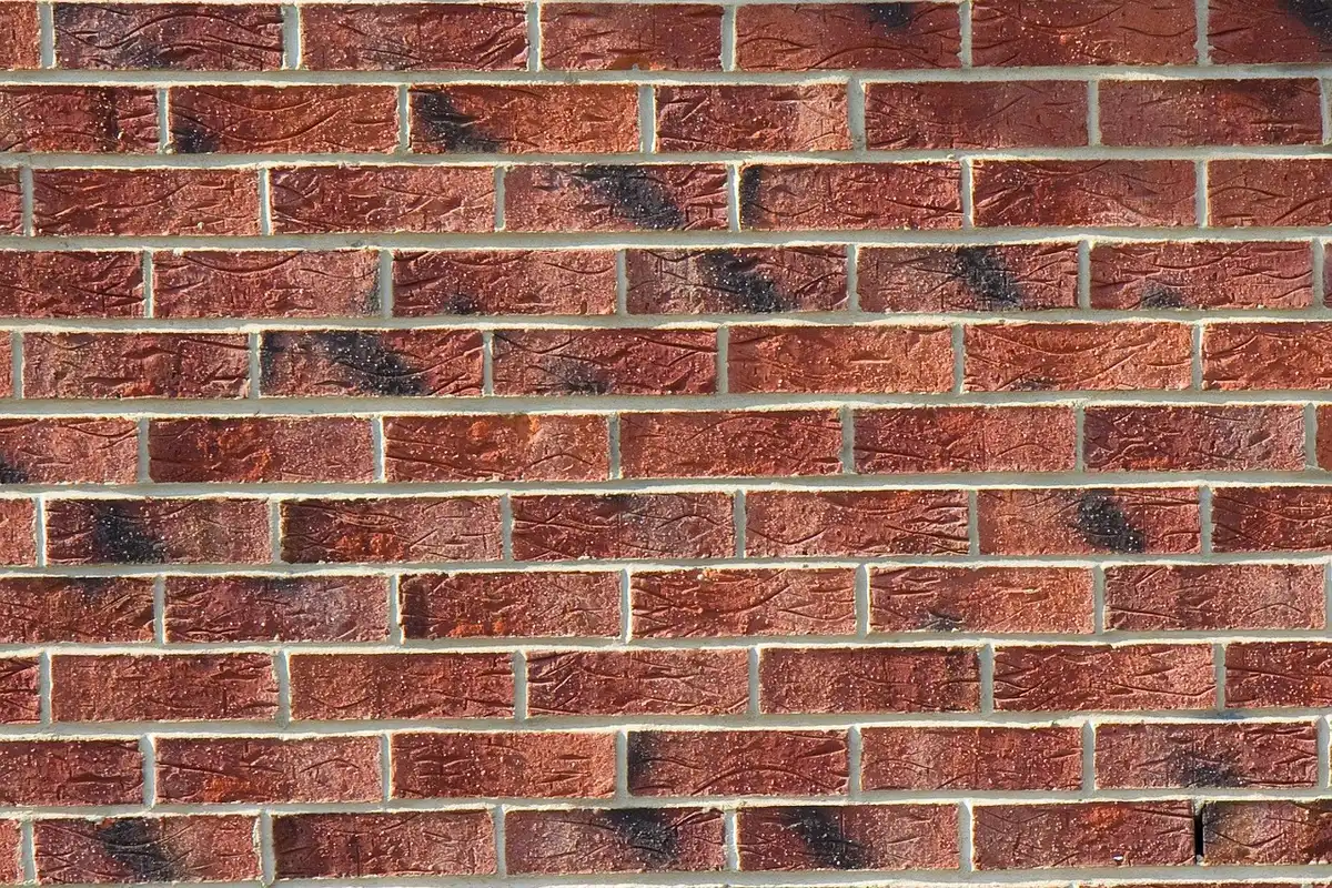 Mains posant des pierres de construction avec du mortier et un niveau sur un chantier