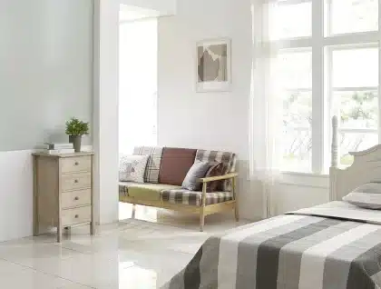 Pièce sous les combles en plein jour avec plans et mètre sur une table